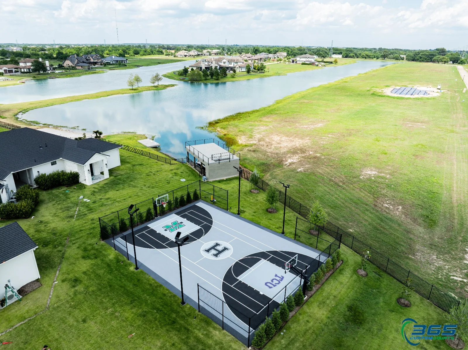 Basketball court aerial by lake with custom logos