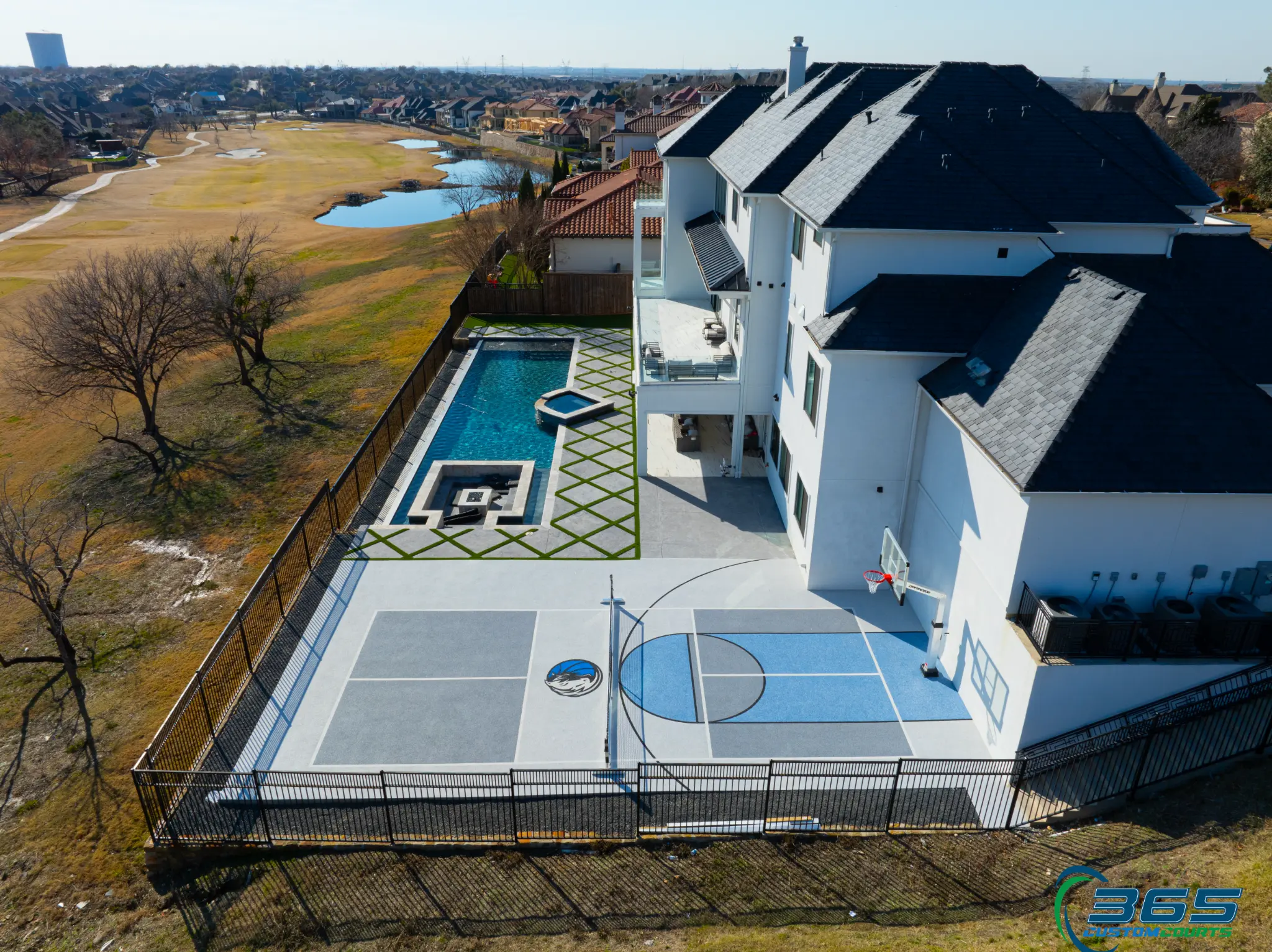 Aerial combo court with pool and golf course views