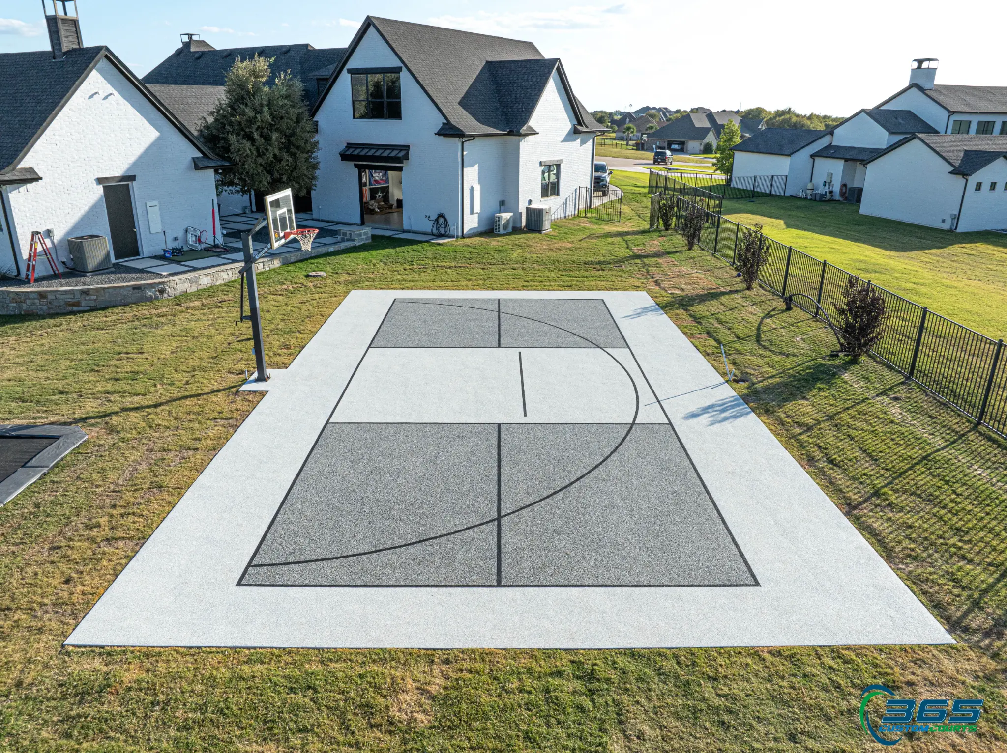 Grey multi-court aerial in residential neighborhood