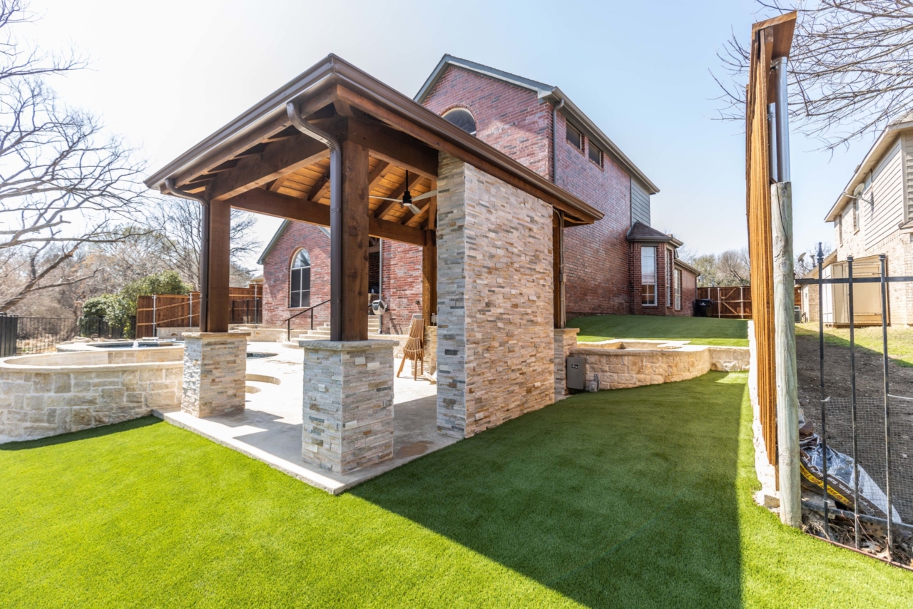 Stone pavilion with turf and hot tub