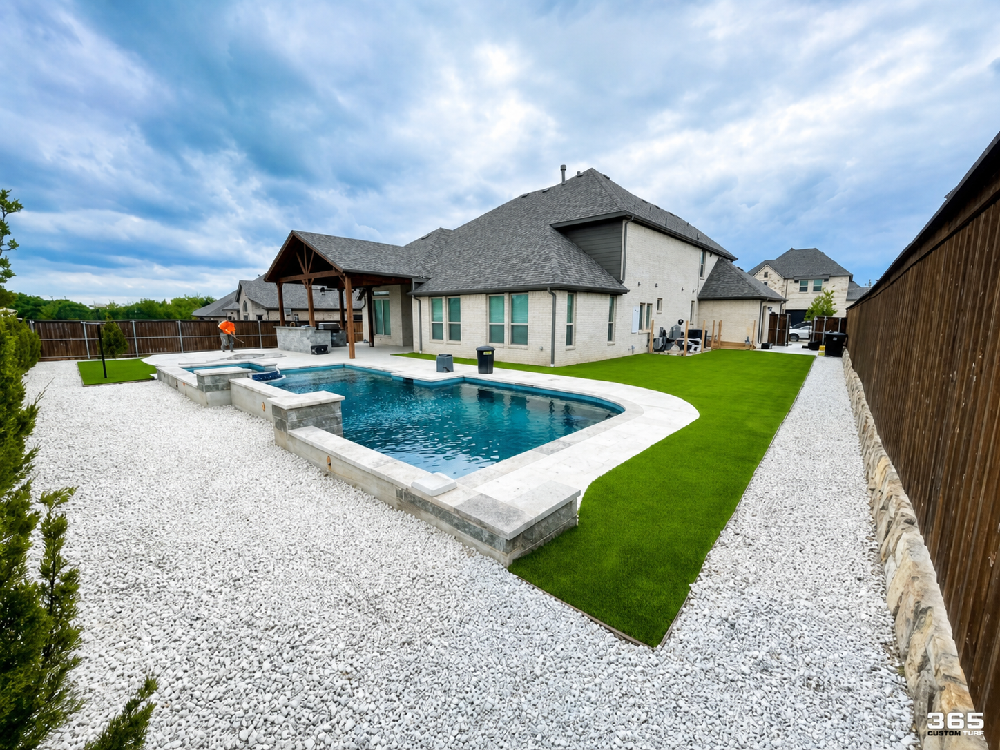 Modern pool with turf and white gravel