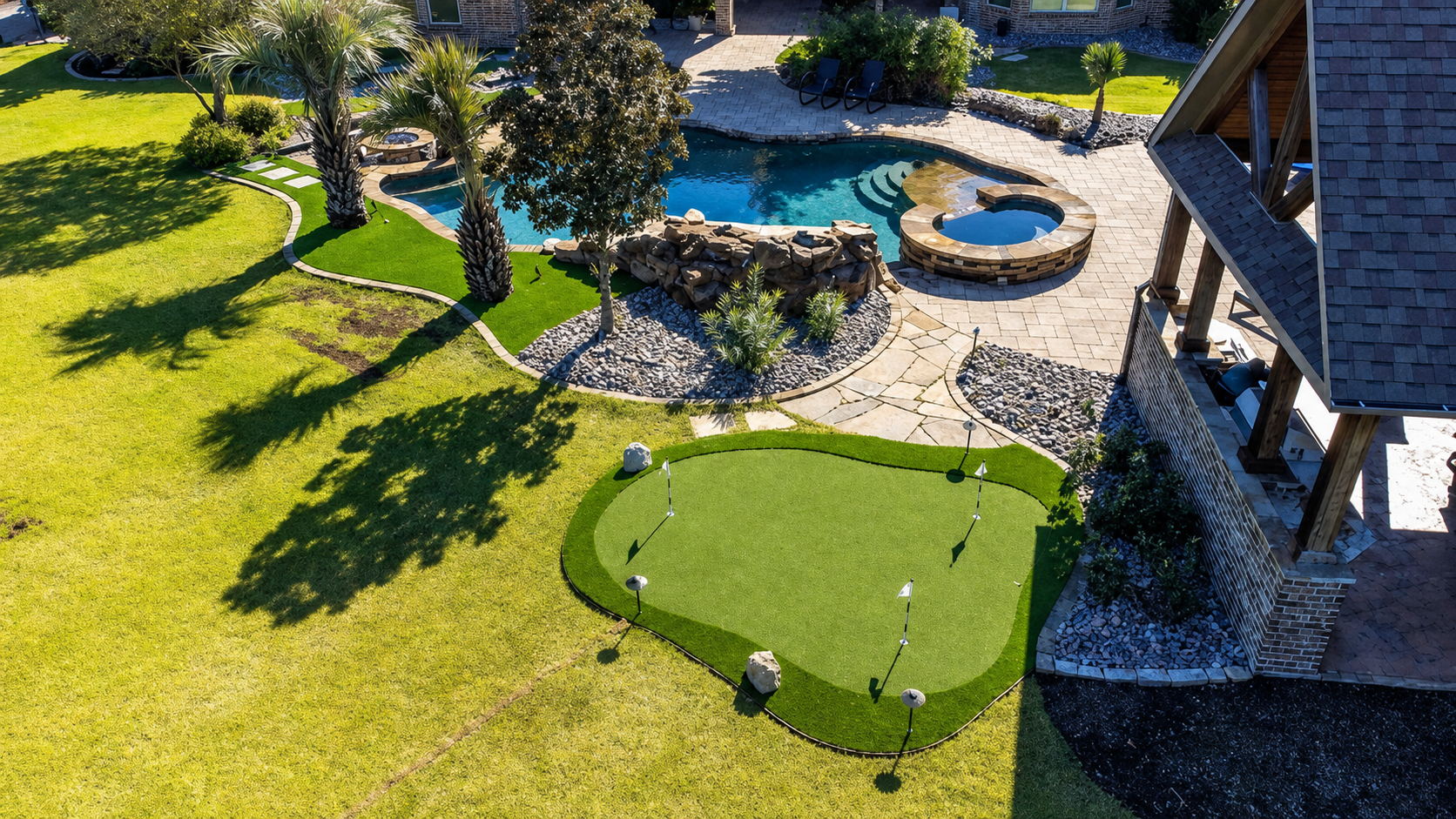 Large turf area with pool and outdoor kitchen