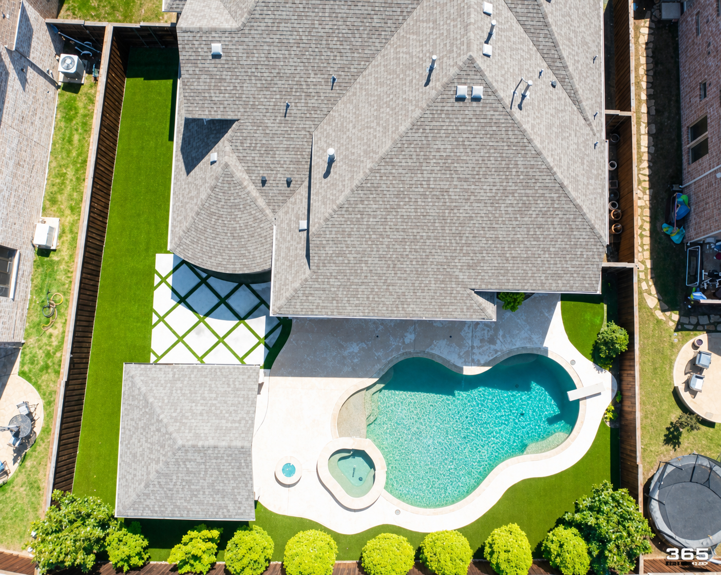 Aerial view of home with turf lawn, pool, and pavilion