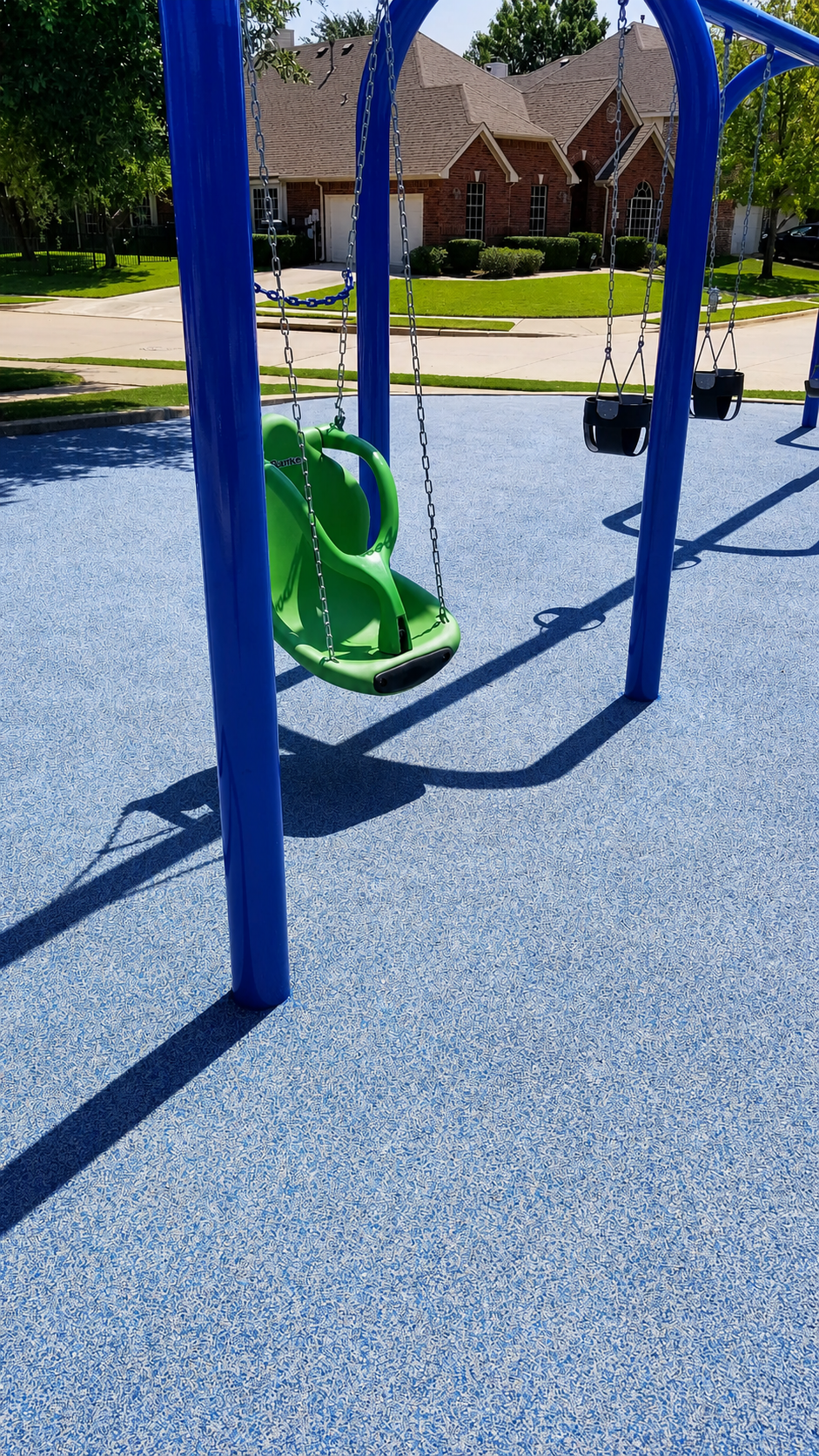 Playground swings with poured rubber surfacing