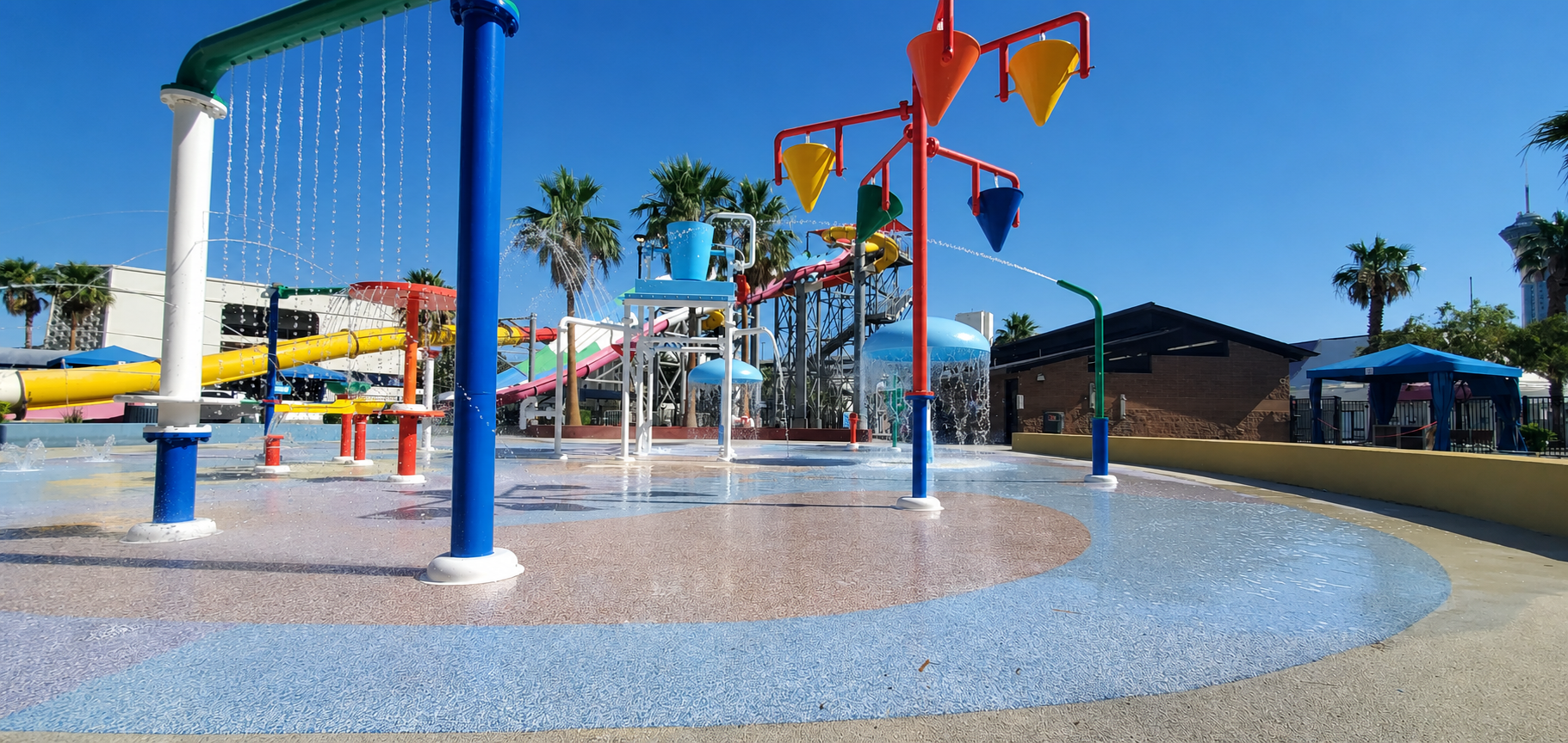 Water park splash pad with colorful surfacing