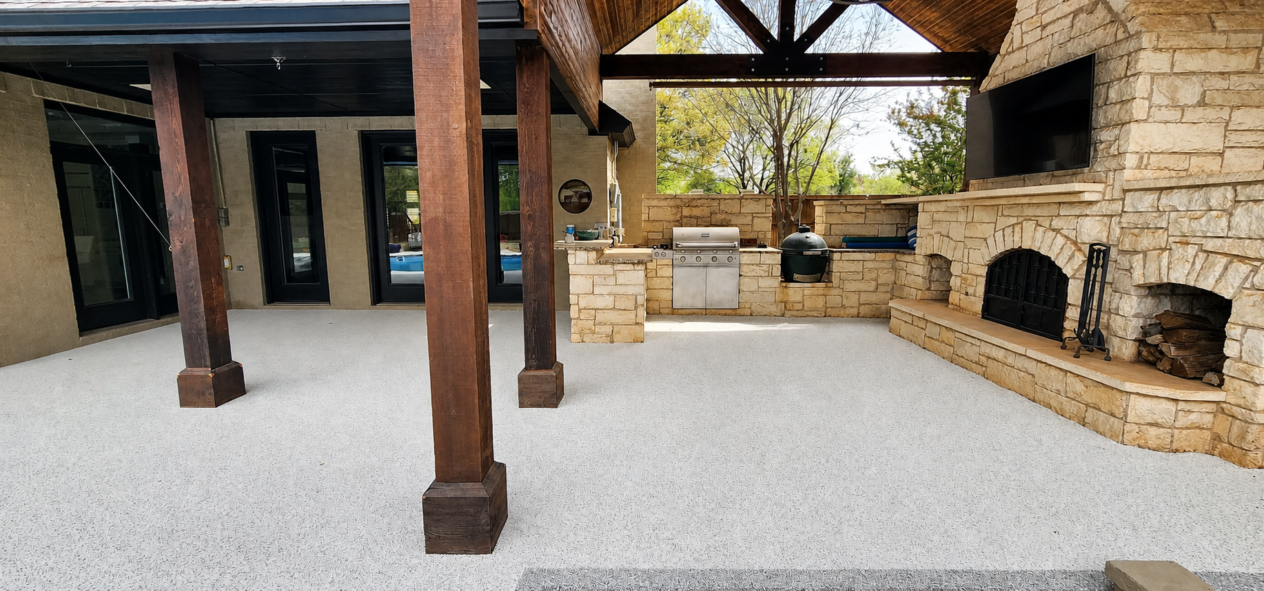 Covered patio with rubber flooring and outdoor kitchen