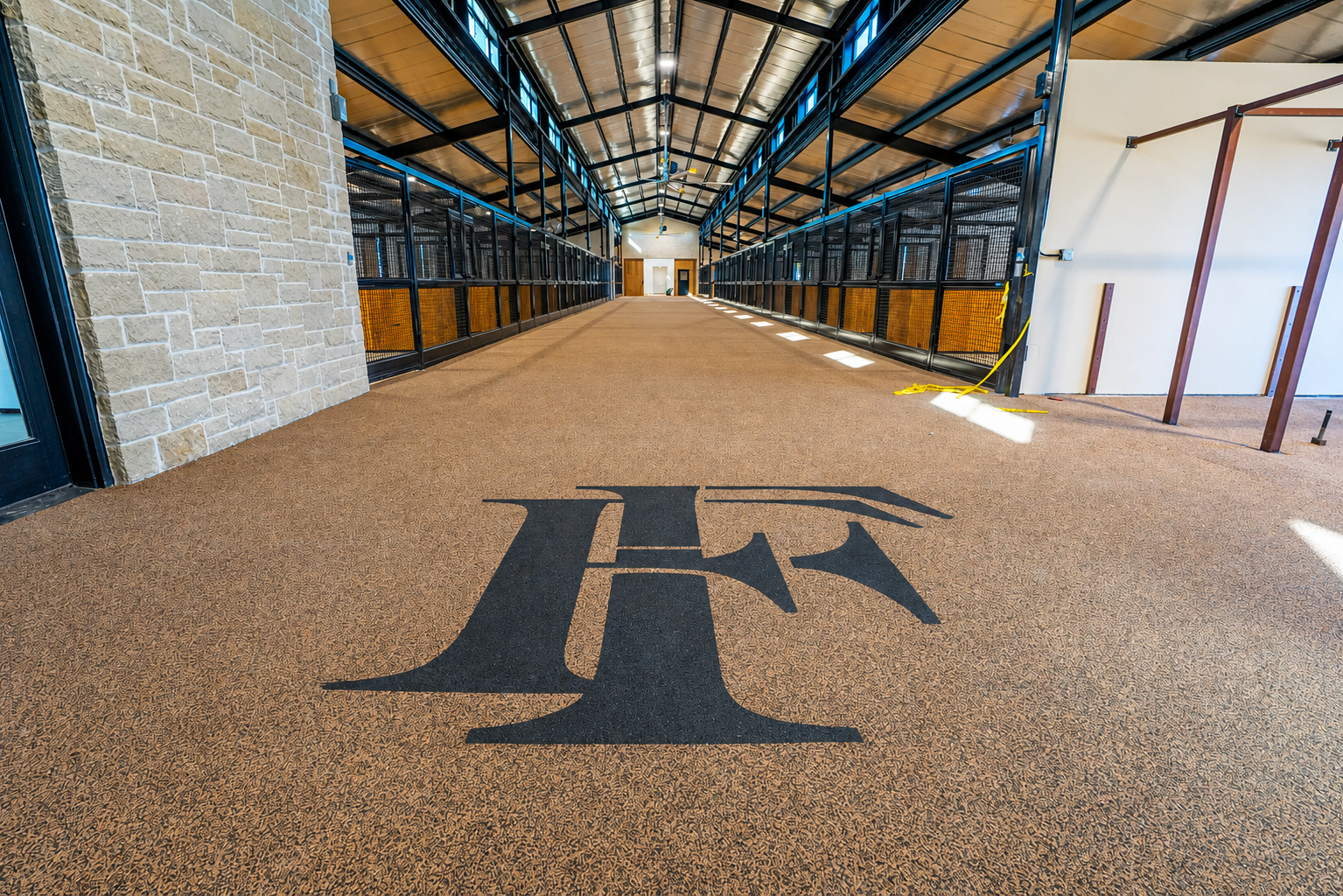 Barn interior with custom logo on rubber floor