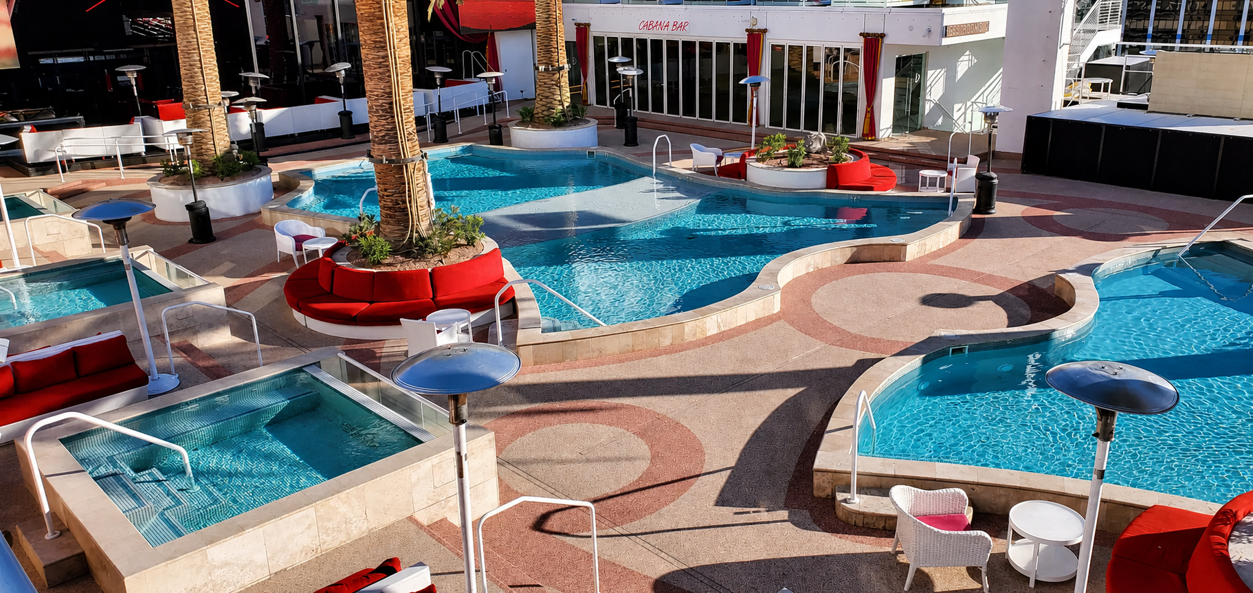 Drais Beachclub pool complex with decorative rubber surfacing and cabana bar