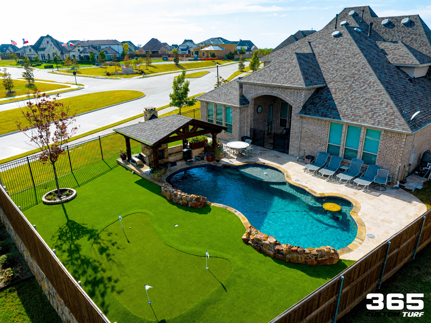 Backyard with pool, putting green, and pergola