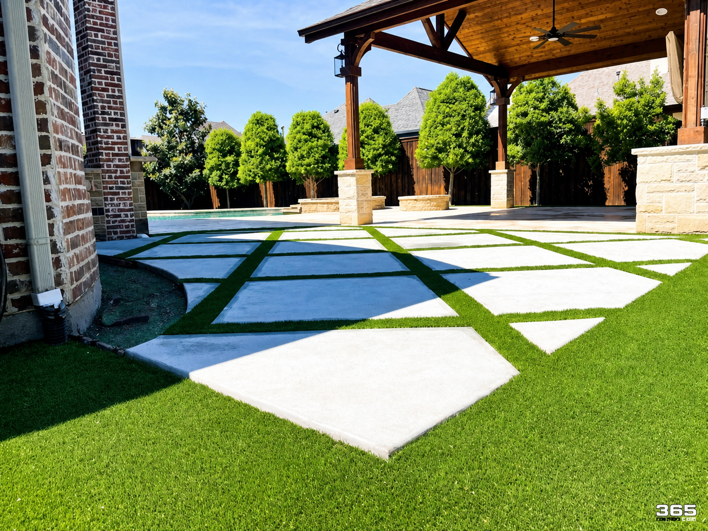 Turf with large concrete pavers and pergola