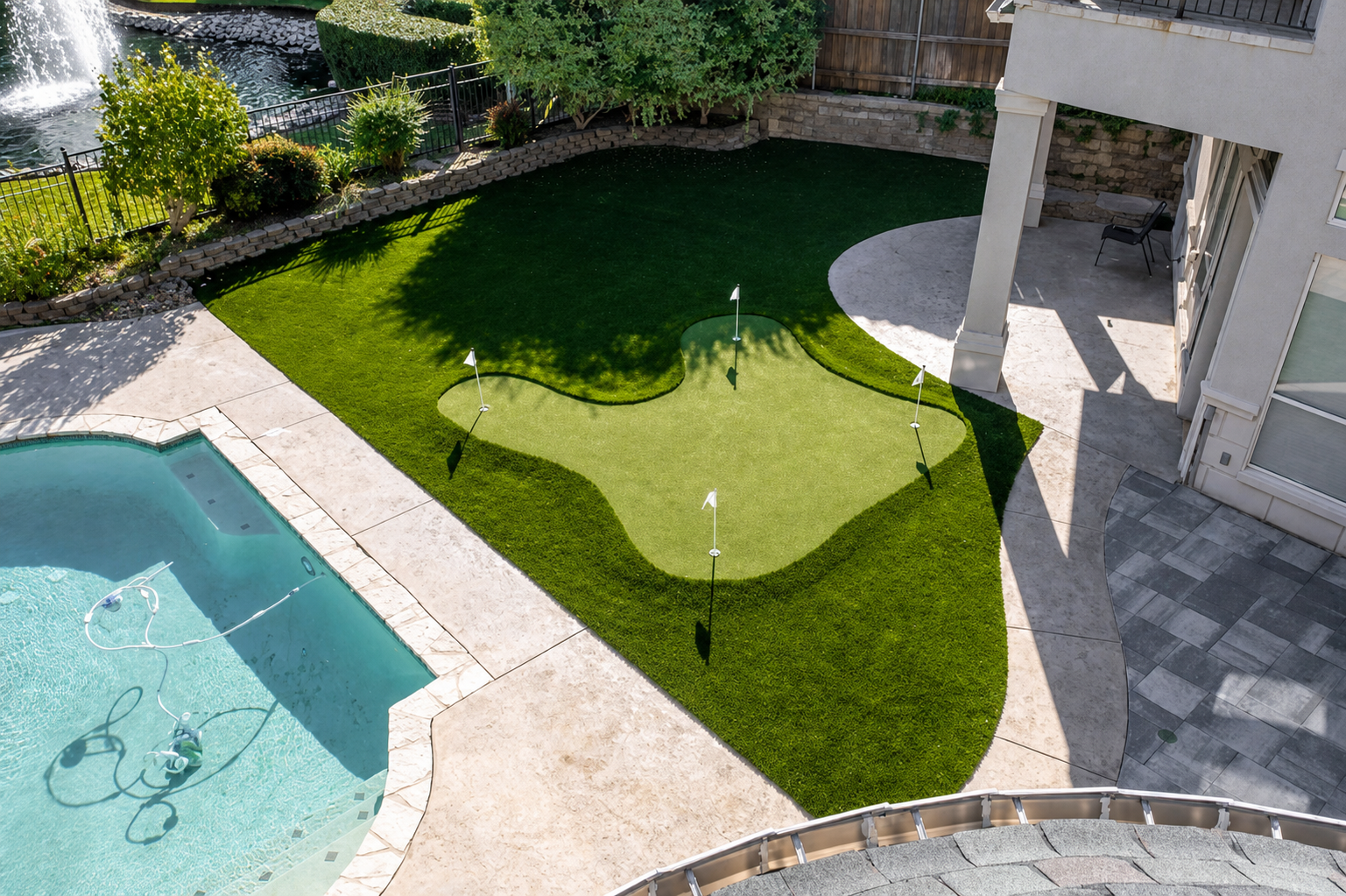 Putting green by pool with lake view