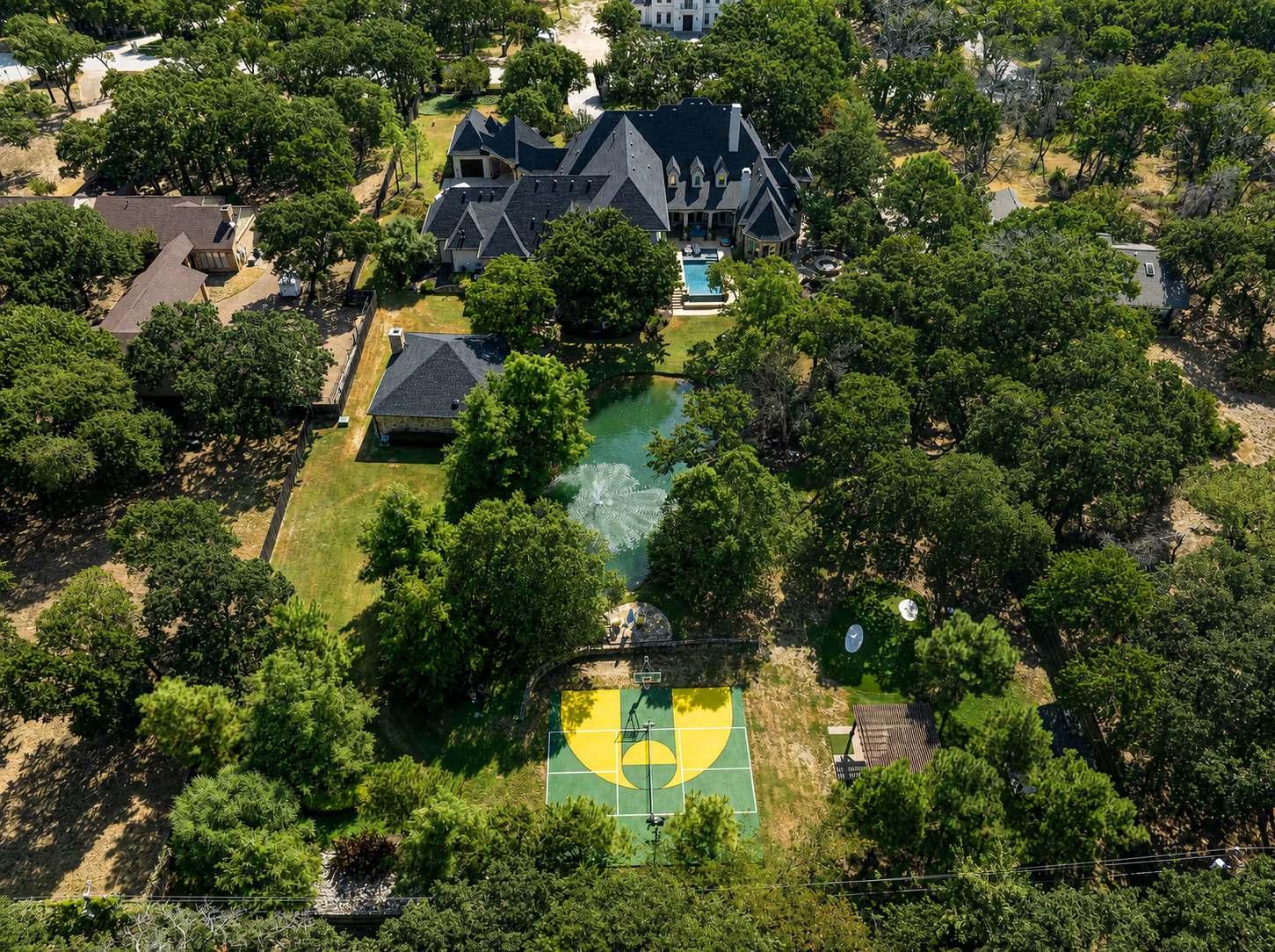 Wooded estate with custom court and pond